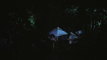 Movie still from “The Mosquito Coast” (1986), directed by Peter Weir – A group of people standing in front of a tent; Extreme Wide shot, High angle