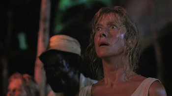 Movie still from “The Mosquito Coast” (1986), directed by Peter Weir – A woman with a black mask on her face; Close Up shot, Low angle
