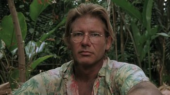 Movie still from “The Mosquito Coast” (1986), directed by Peter Weir – A person wearing glasses and a floral shirt; Close Up shot, Low angle