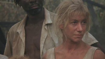 Movie still from “The Mosquito Coast” (1986), directed by Peter Weir – A man and a woman standing next to each other; Close Up shot, Low angle
