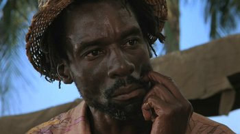 Movie still from “The Mosquito Coast” (1986), directed by Peter Weir – A person with a hat on his head; Close Up shot, Low angle