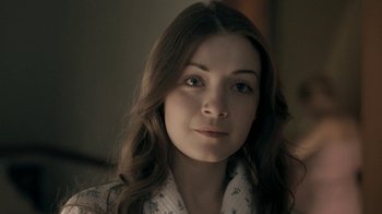 Movie still from “The Moth Diaries” (2011), directed by Mary Harron – A woman with long brown hair wearing a white shirt; Close Up shot, Over the shoulder angle