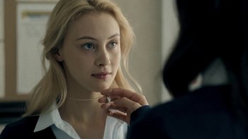 Movie still from “The Moth Diaries” (2011), directed by Mary Harron – A woman looking at her reflection in a mirror; Close Up shot, Over the shoulder angle