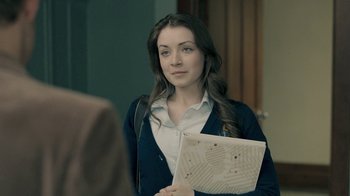 Movie still from “The Moth Diaries” (2011), directed by Mary Harron – A young woman holding a laptop in her hands; Close Up shot, Over the shoulder angle