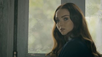 Movie still from “The Moth Diaries” (2011), directed by Mary Harron – A painting of a woman with long hair looking out of a window; Close Up shot, Over the shoulder angle