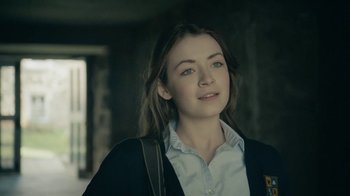 Movie still from “The Moth Diaries” (2011), directed by Mary Harron – A woman with long brown hair wearing a white shirt and black jacket; Close Up shot, Over the shoulder angle