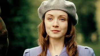 Movie still from “The Moth Diaries” (2011), directed by Mary Harron – A woman wearing a gray hat and a blue shirt; Close Up shot, Over the shoulder angle