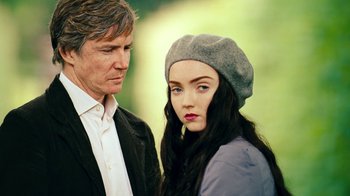 Movie still from “The Moth Diaries” (2011), directed by Mary Harron – A man standing next to a woman wearing a hat; Close Up shot, Over the shoulder angle