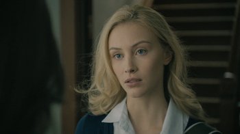Movie still from “The Moth Diaries” (2011), directed by Mary Harron – A woman with blonde hair wearing a white shirt; Close Up shot, Over the shoulder angle