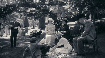 Movie still from “The Moth Diaries” (2011), directed by Mary Harron – A group of people sitting in a park under a tree; Wide shot, High angle
