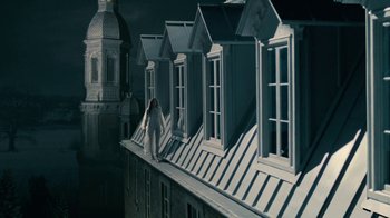 Movie still from “The Moth Diaries” (2011), directed by Mary Harron – A woman standing on the roof of a building; Extreme Wide shot, Low angle