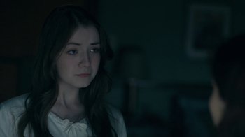 Movie still from “The Moth Diaries” (2011), directed by Mary Harron – A woman with long dark hair is staring into the distance; Close Up shot, Over the shoulder angle