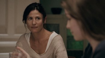 Movie still from “The Moth Diaries” (2011), directed by Mary Harron – A woman sitting in front of another woman in a room; Close Up shot, Over the shoulder angle