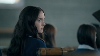 Movie still from “The Moth Diaries” (2011), directed by Mary Harron – A woman with long hair sitting on a bench; Close Up shot, Over the shoulder angle
