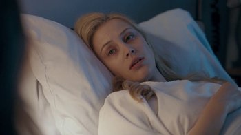 Movie still from “The Moth Diaries” (2011), directed by Mary Harron – A woman laying in a bed with white sheets; Close Up shot, Overhead angle