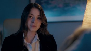 Movie still from “The Moth Diaries” (2011), directed by Mary Harron – A woman with long dark hair wearing a white shirt and jacket; Close Up shot, Over the shoulder angle