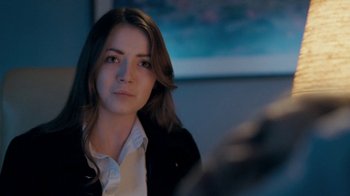 Movie still from “The Moth Diaries” (2011), directed by Mary Harron – A woman sitting in front of a tv in a room; Close Up shot, Over the shoulder angle