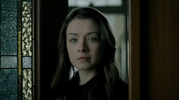 Movie still from “The Moth Diaries” (2011), directed by Mary Harron – A woman with blue eyes looking at the camera; Close Up shot, Over the shoulder angle