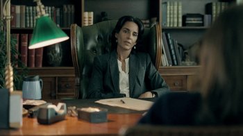 Movie still from “The Moth Diaries” (2011), directed by Mary Harron – A woman sitting at a desk in an office chair; Medium shot, Over the shoulder angle