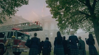 Movie still from “The Moth Diaries” (2011), directed by Mary Harron – A group of people standing in front of a fire truck; Extreme Wide shot, High angle