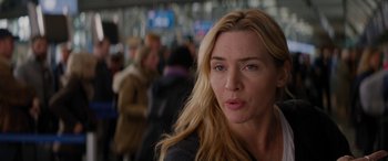 Movie still from “The Mountain Between Us” (2017), directed by Hany Abu-Assad – A person with long blonde hair; Close Up shot, Over the shoulder angle