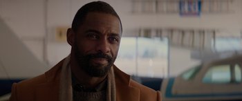 Movie still from “The Mountain Between Us” (2017), directed by Hany Abu-Assad – A person with a beard wearing a jacket; Close Up shot, Over the shoulder angle