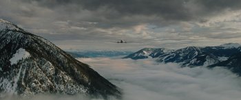 Movie still from “The Mountain Between Us” (2017), directed by Hany Abu-Assad – An air plane flying in the sky above the clouds; Extreme Wide shot, Low angle