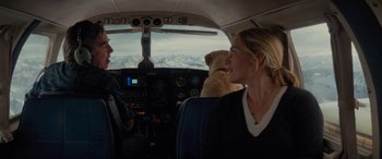 Movie still from “The Mountain Between Us” (2017), directed by Hany Abu-Assad – A woman and a dog in the cockpit of an airplane; Wide shot, High angle