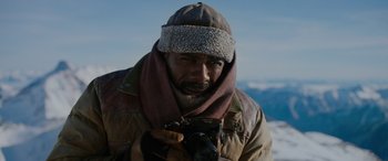 Movie still from “The Mountain Between Us” (2017), directed by Hany Abu-Assad – A man with a beard is holding a camera; Close Up shot, Low angle