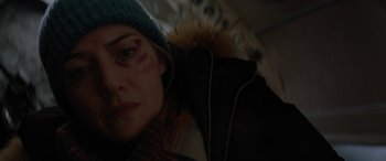 Movie still from “The Mountain Between Us” (2017), directed by Hany Abu-Assad – A person wearing a jacket and a hat; Close Up shot, Over the shoulder angle