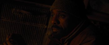 Movie still from “The Mountain Between Us” (2017), directed by Hany Abu-Assad – A person wearing a jacket and a hat; Close Up shot, High angle