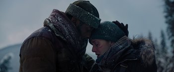 Movie still from “The Mountain Between Us” (2017), directed by Hany Abu-Assad – A man and a woman in winter clothing; Close Up shot, Low angle