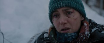 Movie still from “The Mountain Between Us” (2017), directed by Hany Abu-Assad – A person wearing a jacket and a hat; Close Up shot, Over the shoulder angle