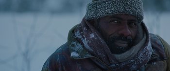 Movie still from “The Mountain Between Us” (2017), directed by Hany Abu-Assad – A person wearing a jacket and a hat; Close Up shot, Over the shoulder angle