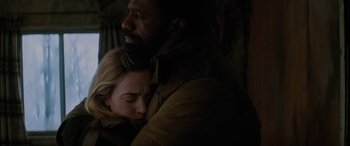 Movie still from “The Mountain Between Us” (2017), directed by Hany Abu-Assad – A man and a woman are hugging in a dark room; Close Up shot, High angle