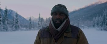 Movie still from “The Mountain Between Us” (2017), directed by Hany Abu-Assad – A man with a beard wearing a winter coat and a hat; Close Up shot, Low angle