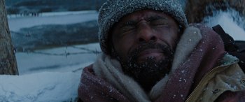 Movie still from “The Mountain Between Us” (2017), directed by Hany Abu-Assad – A man with a beard wearing a winter hat and scarf; Close Up shot, Low angle