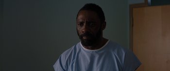 Movie still from “The Mountain Between Us” (2017), directed by Hany Abu-Assad – A man in a blue shirt is looking at the camera; Close Up shot, Over the shoulder angle