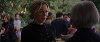 Movie still from “The Mountain Between Us” (2017), directed by Hany Abu-Assad – A person wearing headphones and eating food; Close Up shot, Over the shoulder angle