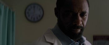 Movie still from “The Mountain Between Us” (2017), directed by Hany Abu-Assad – A person with a clock in the background; Close Up shot, Low angle