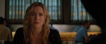 Movie still from “The Mountain Between Us” (2017), directed by Hany Abu-Assad – A person sitting at a table with a glass of wine; Close Up shot, Over the shoulder angle