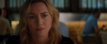 Movie still from “The Mountain Between Us” (2017), directed by Hany Abu-Assad – A person sitting down with her eyes wide open; Close Up shot, Over the shoulder angle