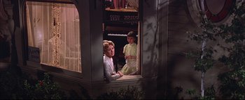 Movie still from “The Music Man” (1962), directed by Morton DaCosta – Two young children sitting in front of an open window; Medium shot, Low angle