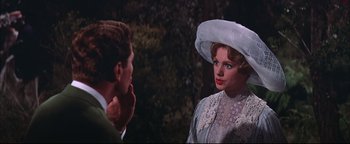 Movie still from “The Music Man” (1962), directed by Morton DaCosta – A man and a woman talking to each other; Close Up shot, Over the shoulder angle
