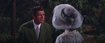 Movie still from “The Music Man” (1962), directed by Morton DaCosta – A man in a suit and a woman in a hat; Medium shot, Over the shoulder angle