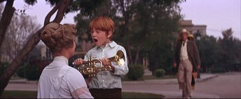 Movie still from “The Music Man” (1962), directed by Morton DaCosta – A young boy holding a trumpet in front of another young boy; Medium shot, Low angle
