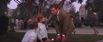 Movie still from “The Music Man” (1962), directed by Morton DaCosta – An older man and two young boys in a park; Medium shot, Over the shoulder angle