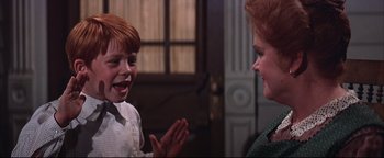 Movie still from “The Music Man” (1962), directed by Morton DaCosta – A woman and a boy talking to each other; Close Up shot, Over the shoulder angle