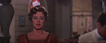 Movie still from “The Music Man” (1962), directed by Morton DaCosta – A woman's face in front of a stained glass window; Close Up shot, Low angle