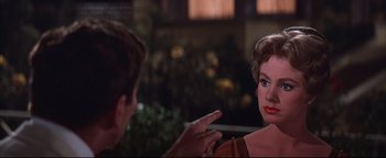 Movie still from “The Music Man” (1962), directed by Morton DaCosta – A man and a woman talking to each other; Close Up shot, Over the shoulder angle